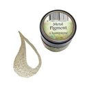 A small jar of metallic pigment powder labeled 'Metal Pigment Champagne' next to a glittery champagne-colored pigment smear on a white background.