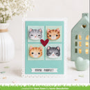 A handmade greeting card featuring four watercolor cat faces in different colors arranged in a 2x2 grid on a mint green background, with a small red heart in the center and the text 'YOU'RE PURRFECT' on a banner at the bottom. The card is styled on a white surface with decorative props including a vase of white flowers, a mint green house-shaped ornament, and a mint green heart.