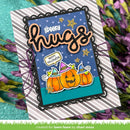 A handmade Halloween greeting card with layered black scalloped borders, a blue polka-dot background, orange glittery 'spooky hugs' lettering, and three orange pumpkins wearing purple witch hats. The card is displayed on a striped cardstock base with purple flowers around it.