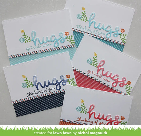 Five handmade greeting cards arranged on a light surface, each with the word "hugs" in different colors, small floral illustrations, and striped ribbon accents. A green banner at the bottom reads "created for lawn fawn by nichol magouirk.
