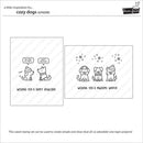 Cozy dogs stamp set packaging insert showing two rectangular design panels with black line drawings of dogs wearing hats and scarves, winter-themed text, and the brand name Paw Prints.