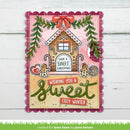 A handmade Christmas greeting card with a gingerbread house, candy canes, green garlands, and the text 'Have a Sweet Christmas' and 'Wishing you a Sweet Cozy Winter,' shown against a white wood background.