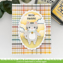 A handmade greeting card featuring a cute gray tabby cat layered over a yellow oval with the text 'YOU'RE PAWSOME'. The card has a multicolor plaid background in orange, yellow, green, and white, and is displayed on a white surface with craft ink pads in the background.