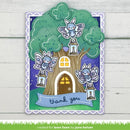 A decorative handmade greeting card featuring a whimsical fairy treehouse scene with three blue-and-white fairy characters, lanterns, a brown tree trunk, green leaves, and a purple night sky. The card has a scalloped white border and a blue banner reading “thank you.