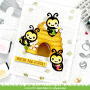 Card with bee-themed design and 'You're Bee-utiful!' text, surrounded by craft supplies.
