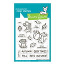 Lawn Fawn photopolymer clear stamps featuring fall-themed cartoon animals, leaves, and phrases like 'Autumn Greetings!' and 'Fall Into Autumn!' on a teal and white backing card.