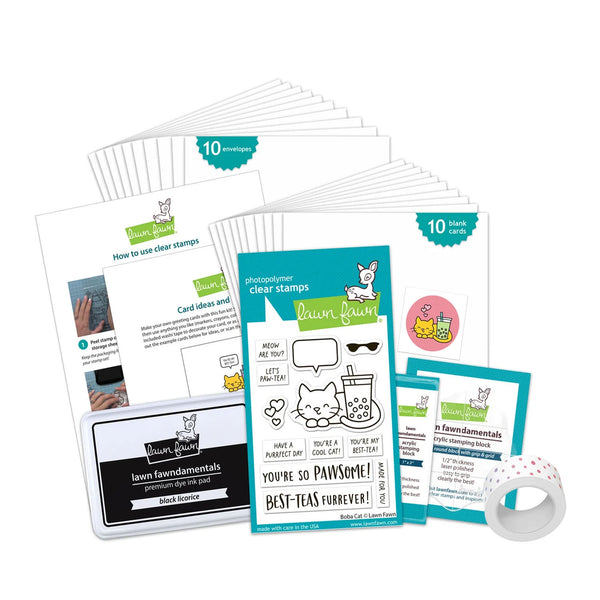 A craft stamp set and ink pad kit arranged on a white background, including a stack of clear stamp sheets, a central stamp card with bunny and tea-themed graphics, instruction sheets, a black ink pad labeled 'inn fundamentals' and 'engraver's stamp', a roll of white tape with pink dots, and two small printed cards.
