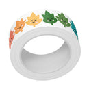 A roll of white tape featuring a repeating pattern of cute, smiling cartoon leaves in orange, yellow, green, and teal, shown on a solid white background.