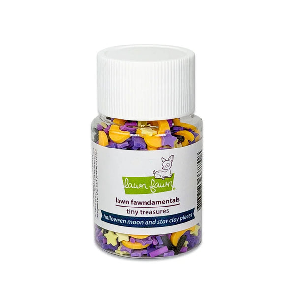 A small clear plastic jar with a white screw cap containing Halloween-themed star and moon clay pieces in purple, yellow, and white. The front label reads 'lawn fawndamentals tiny treasures' and 'Halloween moon and star clay pieces.