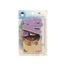 A package of Art Department Design Shop wooden monogram letters, featuring a large purple 'M' and other colorful letters inside a clear blister pack with a blue header card.
