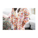 Person wearing a colorful robe in a living room setting