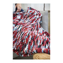 Multicolored textured blanket draped over a couch