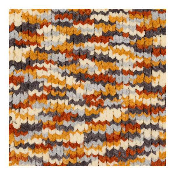 Multicolored textured rug with a pattern of orange, brown, gray, and beige.
