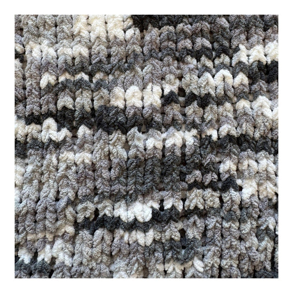 Textured carpet with a pattern of gray, white, and black.