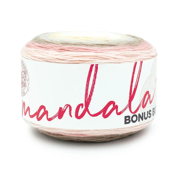 A single ball of Mandala yarn with a variegated color pattern of pink, beige, and cream, wrapped in a white paper label with red script text.