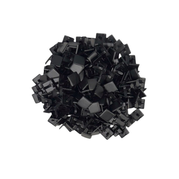 A pile of small black clips or fasteners, photographed from above on a plain white background.