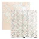 Two sheets of patterned scrapbook paper, one with a pale peach background and white floral line art, and one with a white background and a pink and gray damask pattern.