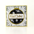 A square handmade Christmas greeting card featuring a large circular ornament design in black, white, and gold with the text 'Happy Christmas' in gold script. The card has a gold border and is photographed on a clean white background with a soft reflection.