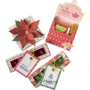 Three decorated gift boxes containing candles are arranged on a white background. One box is open and shows pink patterned interior with pockets holding Wickwick and Goldwell candles.
