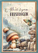 A completed jigsaw puzzle featuring a whimsical winter scene with a mushroom wearing a blue knit hat and scarf, a butterfly, rocks, and the Dutch text 'Heel fijne FEESTDAGEN' across the top. The puzzle is framed in light wood and set against a teal background.