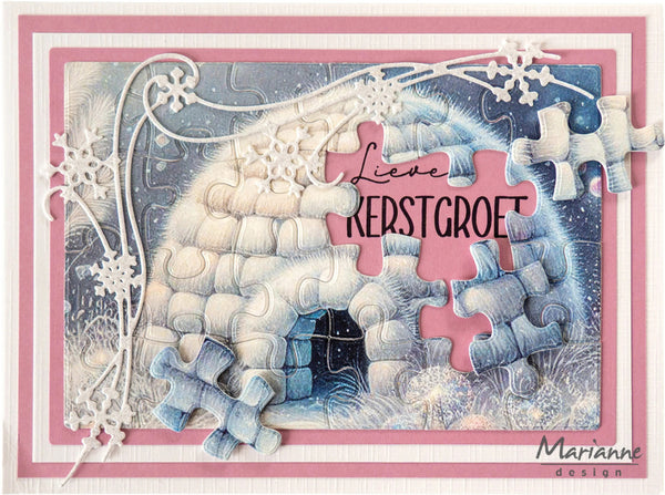 A handmade greeting card featuring a winter igloo made of layered paper and embossed textures, decorated with white snowflakes and puzzle-piece cutouts. The center has a pink puzzle piece with the Dutch greeting 'Lieve KERSTGROET' in black script.