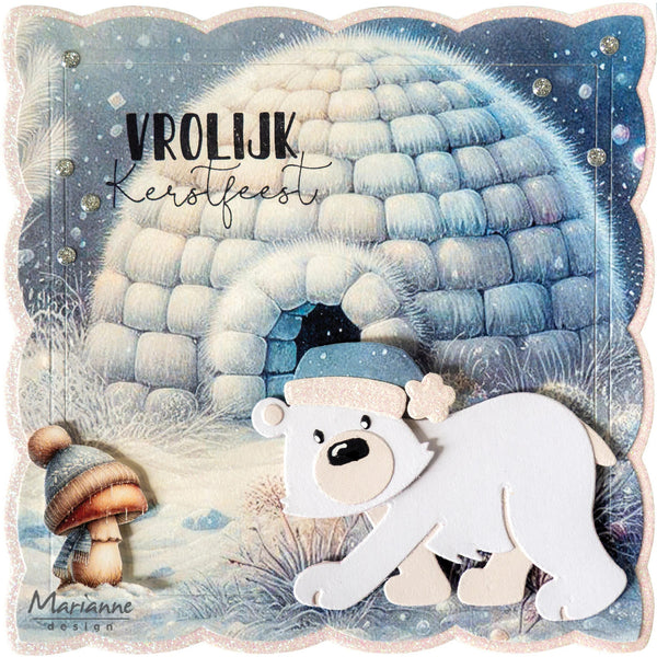 A square decorative card or print featuring a snowy winter scene with a blue igloo, a white polar bear in a blue hat, a small mushroom, and the text 'VROLIJK Kerstfeest' plus 'Marianne Design' at the bottom.