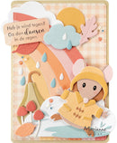 A handmade layered card featuring a cute mouse character in a yellow raincoat and hood, set against a pastel rainbow, clouds, leaves, and Dutch text on a gingham background.