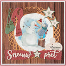 A square handmade holiday card or scrapbook design featuring a winter scene with two snowballs, green mittens, a red scarf, glittery star embellishments, and a wood-grain background. The card includes the text 'Sneeuw pret' and a 'Marianne design' logo.