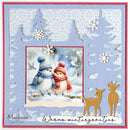 A square handmade card featuring a central photo of two snowy birds wearing blue and red winter hats and scarves, surrounded by layered light blue and red borders with white snowflake cutouts, tree silhouettes, and two gold deer at the bottom. The card includes the text 'Marianne design' and 'Warme wintersgrätjes'.
