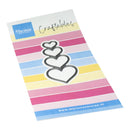 A sheet of Mariannes Design craftables featuring three stacked heart outlines with black borders and white fill, set against a background of pastel pink, yellow, blue, and white horizontal stripes.