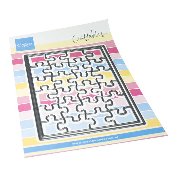 A metal jigsaw puzzle cutter sheet from Marien Design, shown on its printed backing card. The card features a colorful striped border in pastel pink, yellow, blue, and white, with the Marien Design logo in the top-left corner and the word 'Craftables' written in script at the top.