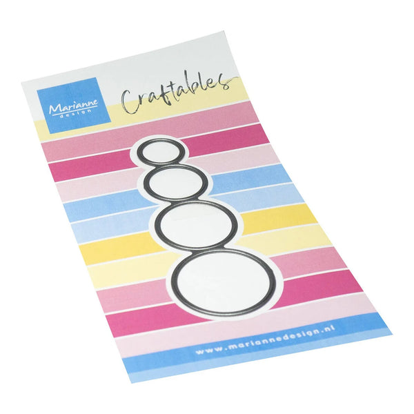 A craft die set by Mariannes Design for making four nested circles, shown on its branded retail backing card with pastel striped background.