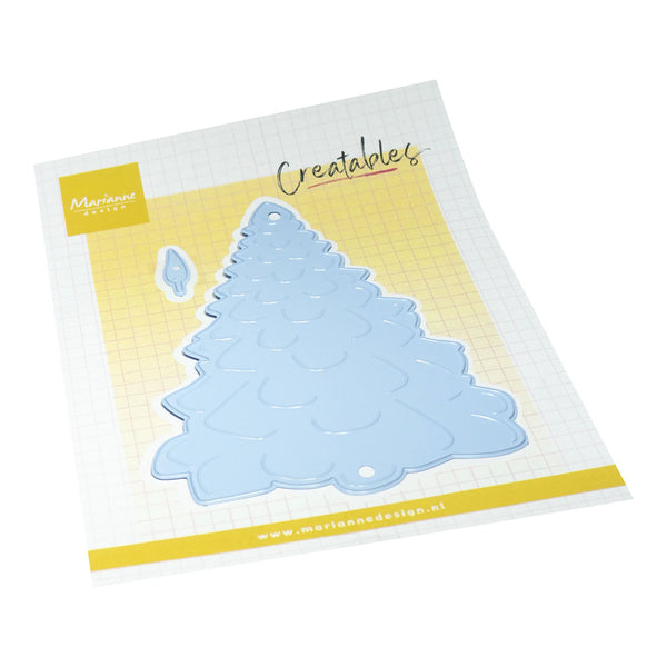 A light blue Christmas tree-shaped die set by Marienmeier Creations, displayed on its white and yellow grid-patterned backing card.