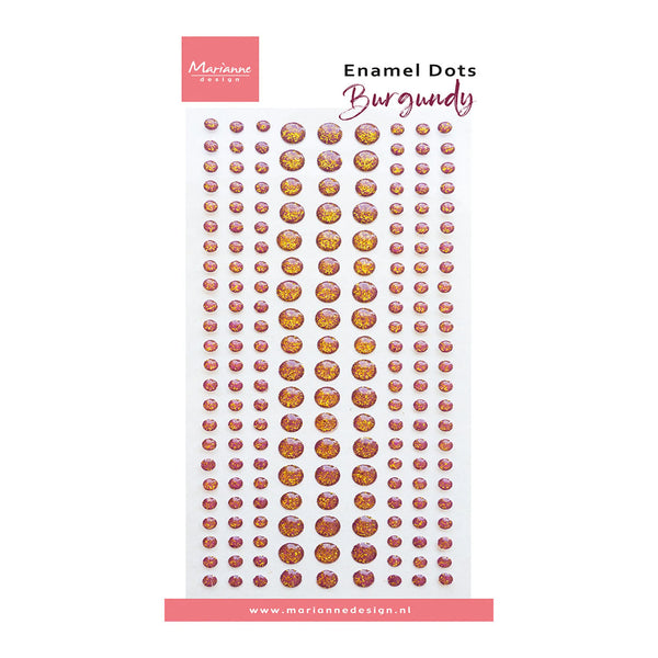 A sheet of Marianne Design Burgundy Enamel Dots, featuring rows of small round stickers with a metallic gold and deep red pattern on a white backing card.