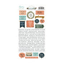 A sheet of scrapbook stickers from Minnie May's Memory Bank, featuring various retro-style labels, stickers, and a central wreath with the words 'good energy' in gold foil. The sheet includes text elements like 'good times', 'believe in yourself', and 'focus on the good'.