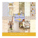 A square product display for a scrapbook paper collection titled 'Camino de Santiago Buen Camino' showing 16 double-sided patterned papers arranged in a grid with a central blue label and yellow arrow. The papers feature vintage Spanish travel motifs including maps, postcards, flowers, boots, a cow, a church, and rustic scenes in soft pastel and neutral tones.
