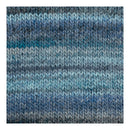 A close-up of a knitted fabric swatch with horizontal stripes in shades of blue, teal, gray, and white.