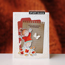 A handmade layered card by Penny Black featuring a die-cut illustration of a girl in a red sweater, autumn leaves, a butterfly, and lined paper on a textured white background, set against a warm orange-brown gradient backdrop.