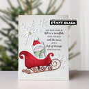 A handmade Christmas greeting card featuring a white cat in a red sleigh with a green bow, set against a textured white background with embossed snowflakes and a copper-colored metal sleigh base. The card includes the text 'MAY YOUR HEART BE light as a snowflake, YOUR TROUBLES melt like snow, AND A DRIFT OF BLESSINGS SURROUND YOU.