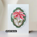 A handmade layered card featuring a pink poinsettia flower with green leaves, set against a scalloped green and white background. The card is displayed on a light surface with a brand label at the bottom that reads 'papercrafting with Penny Black' and 'PENNY BLACK'.