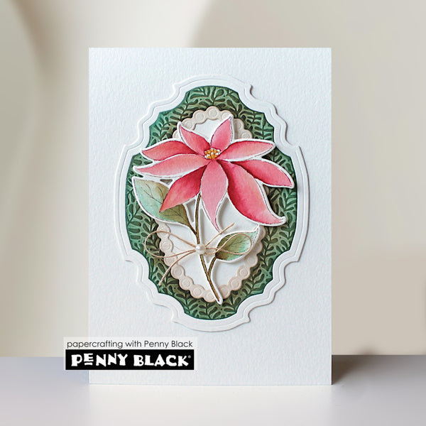 A handmade layered card featuring a pink poinsettia flower with green leaves, set against a scalloped green and white background. The card is displayed on a light surface with a brand label at the bottom that reads 'papercrafting with Penny Black' and 'PENNY BLACK'.