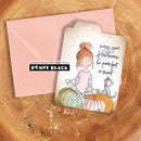 A handmade greeting card with a watercolor illustration of a girl and cat sitting on pumpkins, shown with a pink envelope on a wooden surface. The card reads 'may your Halloween be pump- feet & sweet' and features the Penny Black brand logo.