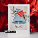 A handmade Christmas greeting card featuring a blue bell, red poinsettia, green holly leaves, and beige holly accents on a textured beige background. The card is displayed against a blurred red festive background, with a 'Penny Black' brand label at the bottom left.