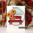 A handmade greeting card by Penny Black featuring a red bench, orange and yellow sunflowers, and the text 'COUNT YOUR BLESSINGS' inside an embroidery hoop design, set against a blurred autumn background.