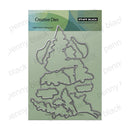 Penny Black Creative Dies steel cutting die set on a light green backing card, featuring multiple irregular metal cutline shapes.