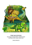 Display of colorful dinosaur-themed stamps with decorative elements, featuring 'Pink Ink Designs' branding.