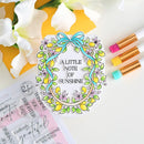 Decorative clear stamp with floral design and text 'A Little Note of Sunshine' on a white background.