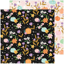A sheet of patterned paper with a black background covered in autumn floral and pumpkin motifs, with two additional patterned paper sheets partially visible behind it on a white background.