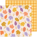 A sheet of patterned paper with an autumn leaf print in orange, yellow, purple, and peach on a cream background, layered over a second sheet showing a matching yellow-orange plaid pattern.