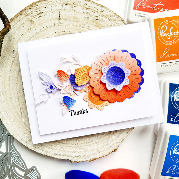 Greeting card with colorful floral design on a wooden surface
